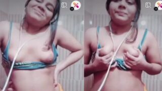 Naughty playgirl enjoys playing with her boobs